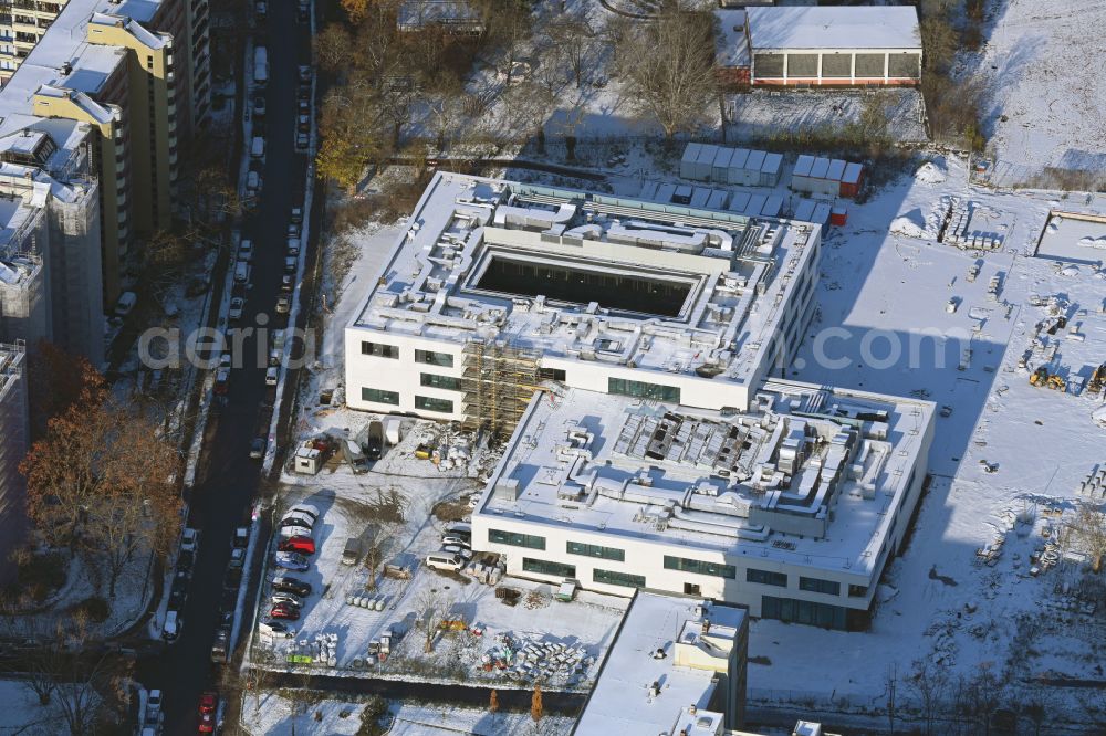 Berlin from the bird's eye view: Wintry snowy new construction site of the school building Leonardo-da-Vinci-Gymnasium on Christoph-Ruden-Strasse in the district Buckow in Berlin, Germany