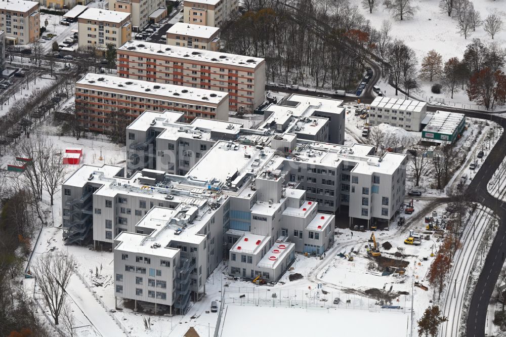 Berlin from above - Wintry snowy new construction site of the school building on Allee of Kosmonauten in the district Lichtenberg in Berlin, Germany