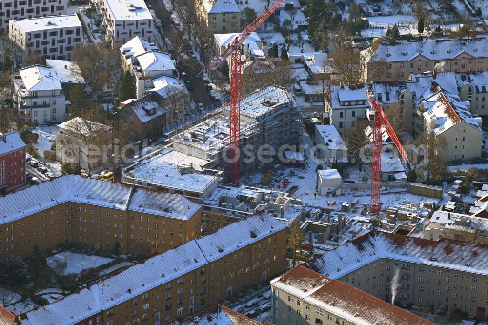 Aerial image Berlin - Wintry snowy construction site for the multi-family residential building COe Berlin on street Annenallee - Haemmerlingstrasse in the district Koepenick in Berlin, Germany