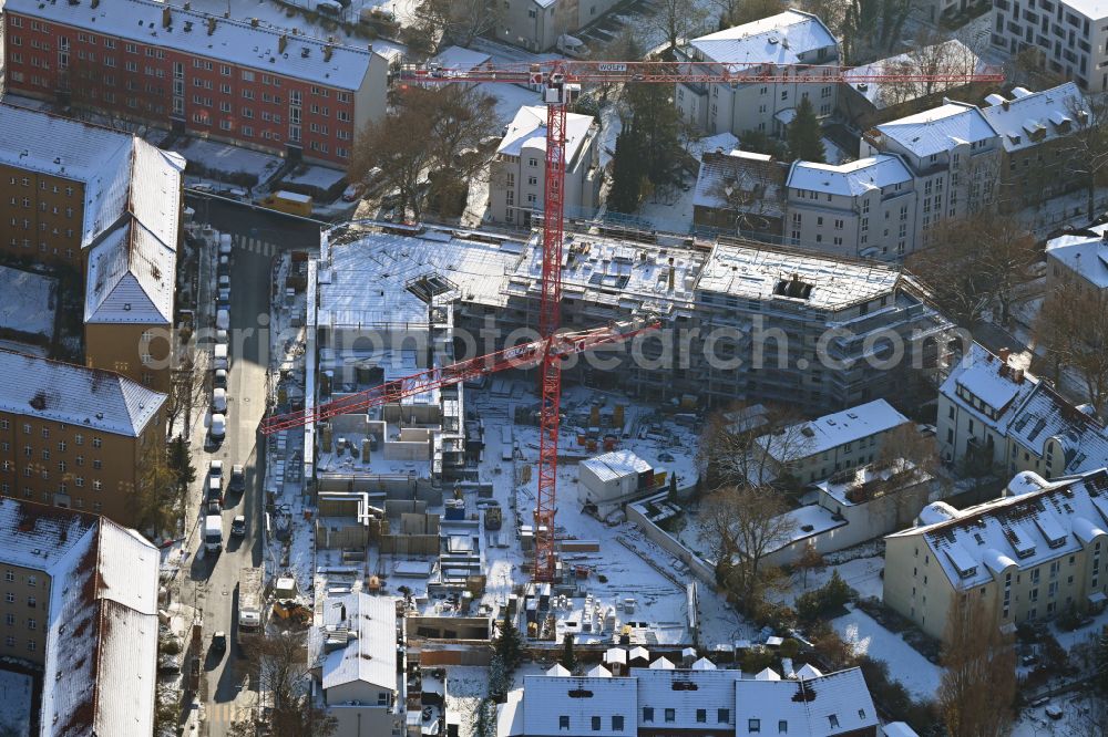 Berlin from above - Wintry snowy construction site for the multi-family residential building COe Berlin on street Annenallee - Haemmerlingstrasse in the district Koepenick in Berlin, Germany