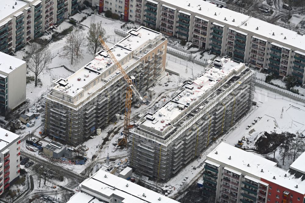 Aerial photograph Berlin - Wintry snowy construction site for the multi-family residential building on street Bodo-Uhse-Strasse in the district Hellersdorf in Berlin, Germany