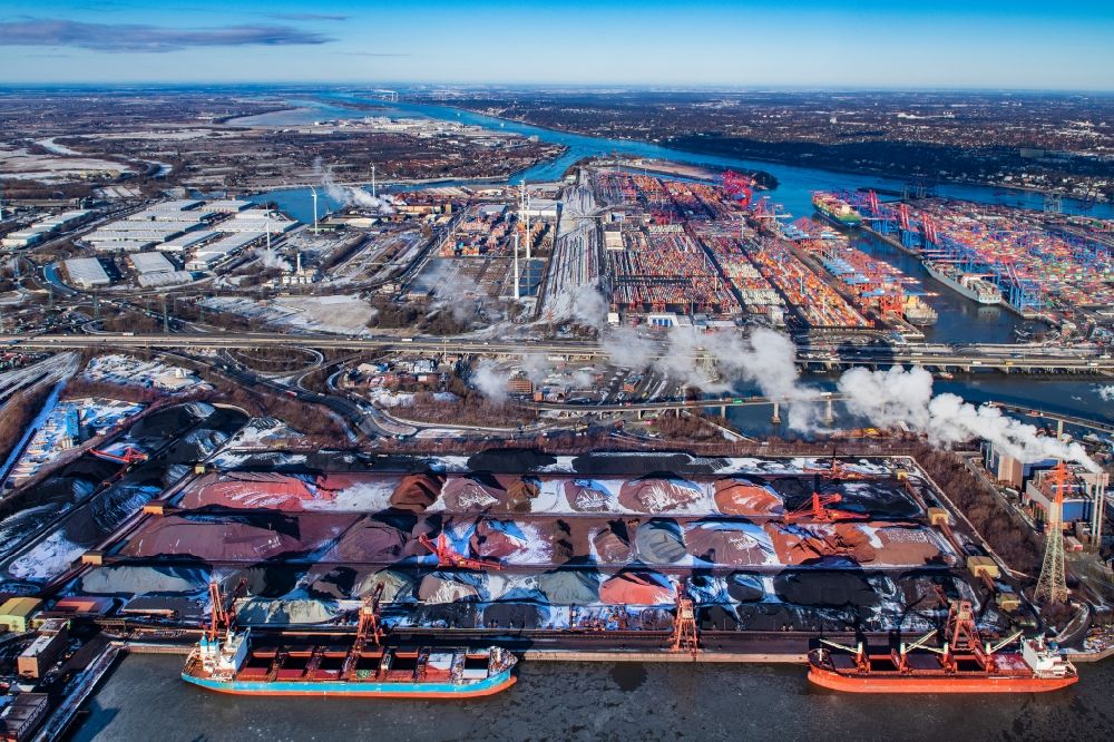 Hamburg from the bird's eye view: Wintry snowy loading zone for sand and bulk material in the harbour and refuse utilisation facility MVR Muellverwertung Rugenberger Damm GmbH & Co. KG at the Koehlbrandbruecke in Hamburg