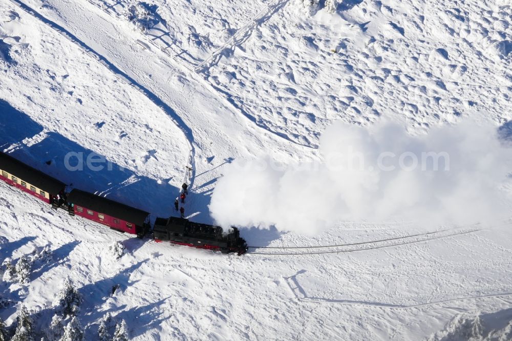 Aerial image Schierke - Wintry snowy the railway Brockenbahn with a Mallet-Engine / steam locomotive / railcar, a narrow-gauge railway, during a trip at the Brocken mountain in Saxony-Anhalt