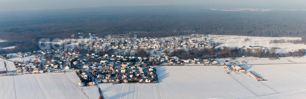 Aerial image Scheibenhard - Wintry snowy Village - view on the edge of agricultural fields and farmland in Scheibenhard in Grand Est, France