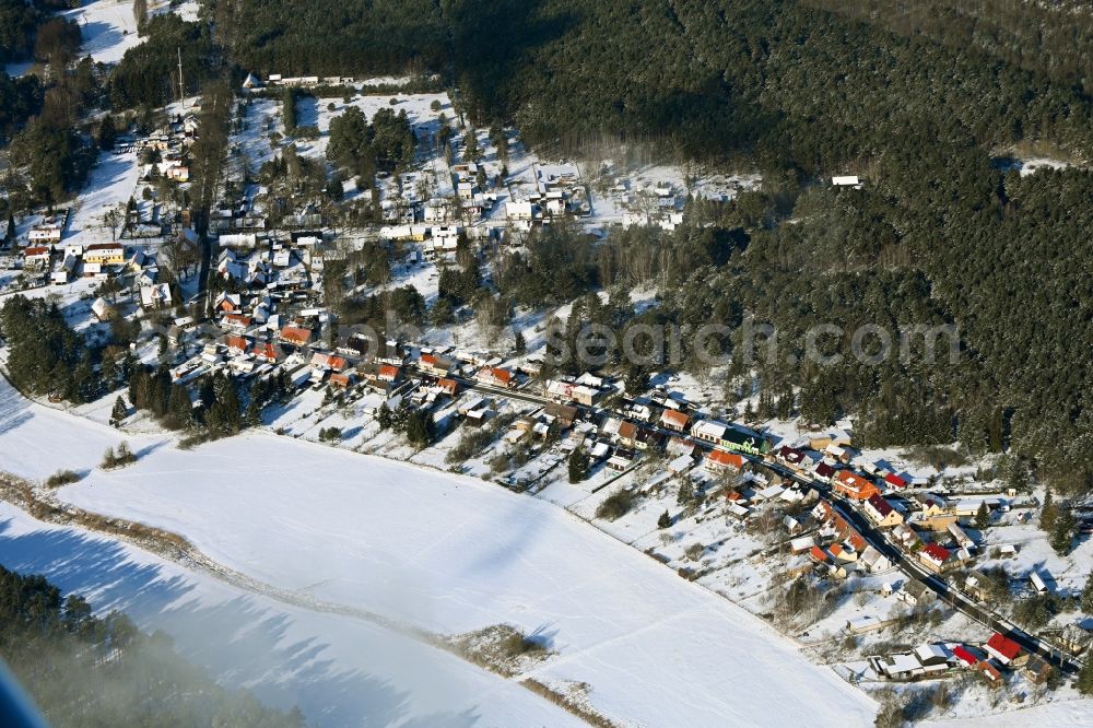 Aerial image Groß Dölln - Wintry snowy village - view on the edge of forested areas in Gross Doelln in the state Brandenburg, Germany