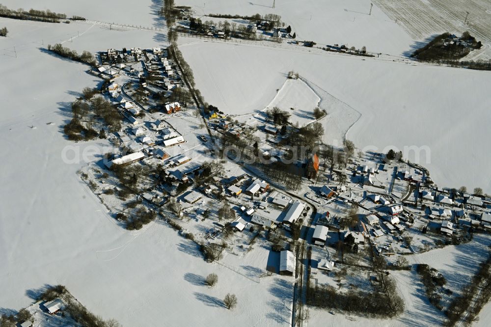 Aerial image Kenz - Wintry snowy agricultural land and field boundaries surround the settlement area of the village on street Kastanienallee in Kenz in the state Mecklenburg - Western Pomerania, Germany