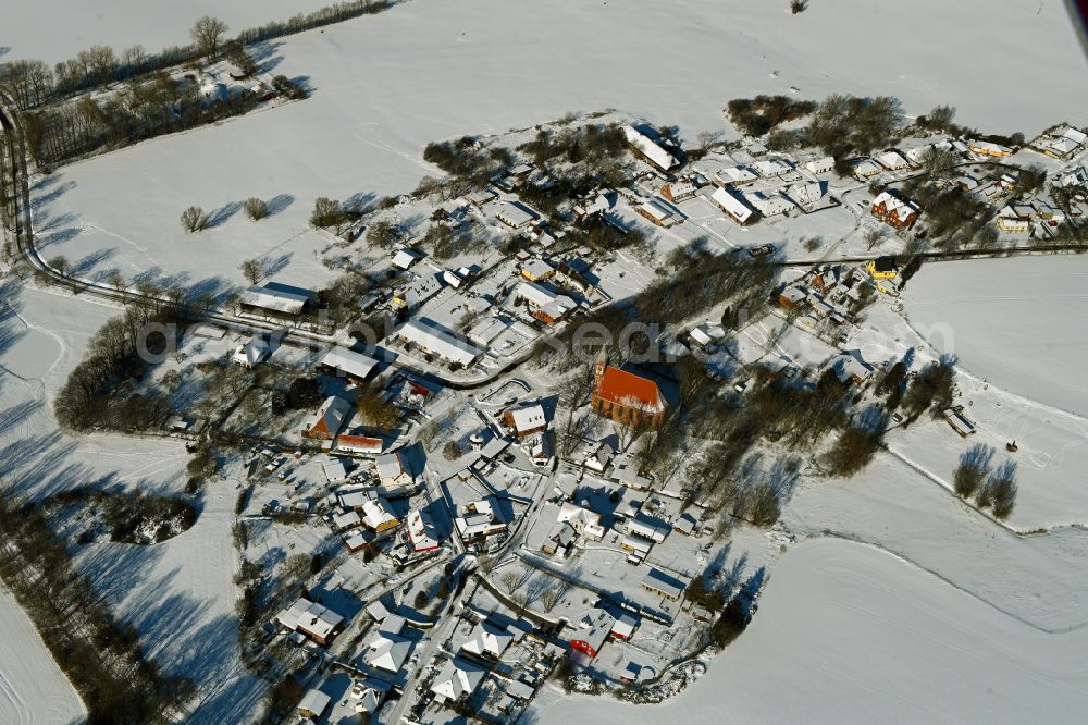Kenz from above - Wintry snowy agricultural land and field boundaries surround the settlement area of the village on street Kastanienallee in Kenz in the state Mecklenburg - Western Pomerania, Germany