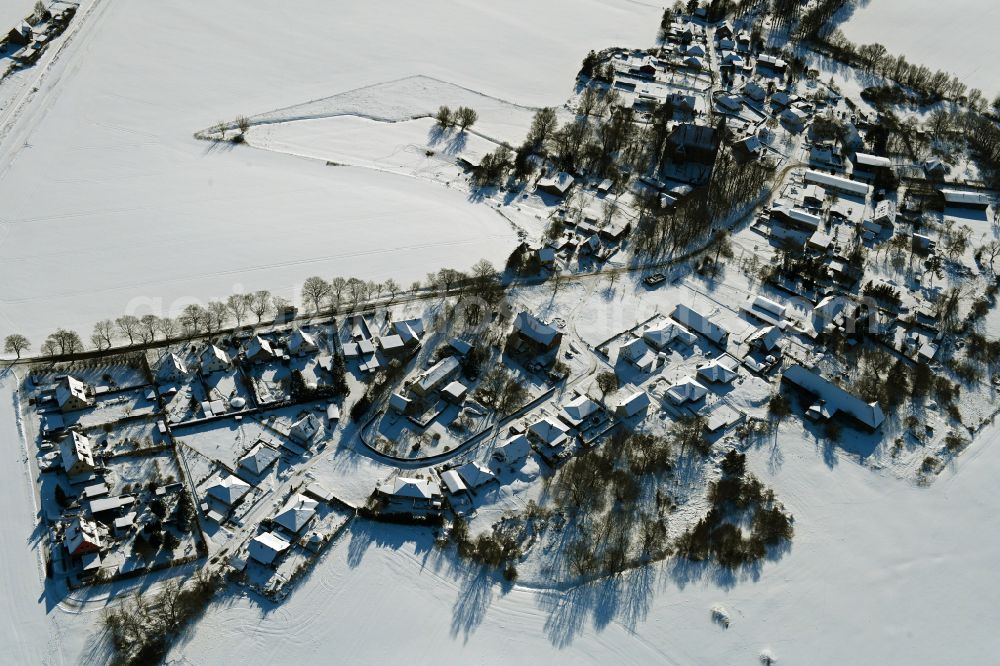 Kenz from above - Wintry snowy agricultural land and field boundaries surround the settlement area of the village on street Kastanienallee in Kenz in the state Mecklenburg - Western Pomerania, Germany