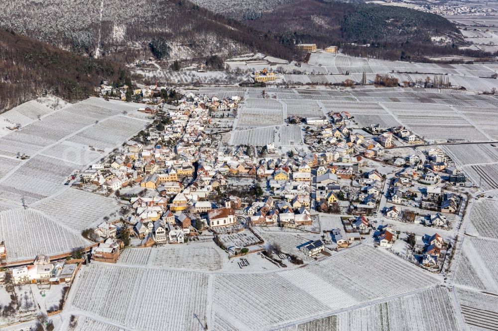Weyher in der Pfalz from the bird's eye view: Wintry snowy village on the edge of vineyards and wineries in the wine-growing area in Weyher in der Pfalz in the state Rhineland-Palatinate, Germany