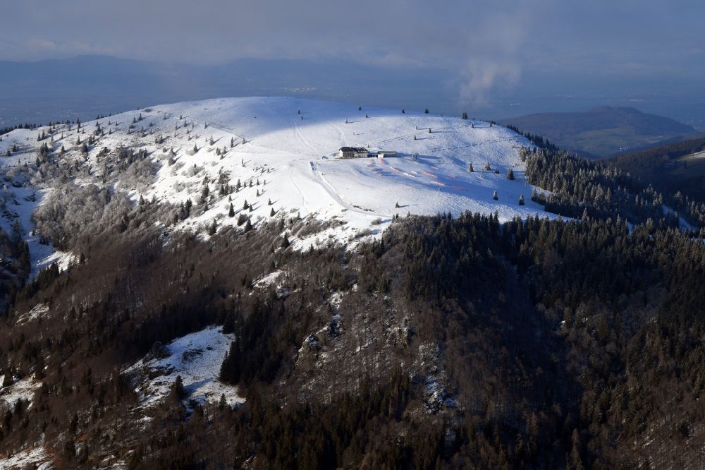 Kleines Wiesental from above - Wintry snowy forest and mountain scenery in the Black Forest with the snow covered summit of Belchen in Kleines Wiesental in the state Baden-Wurttemberg, Germany