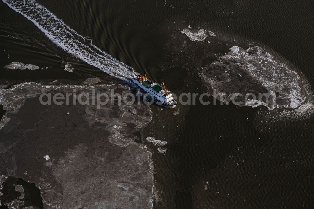 Aerial photograph Juist - Winter aerial view Journey of a ferry ship Frisia X between floating ice floes in front of the North Sea island of Juist in the state of Lower Saxony, Germany