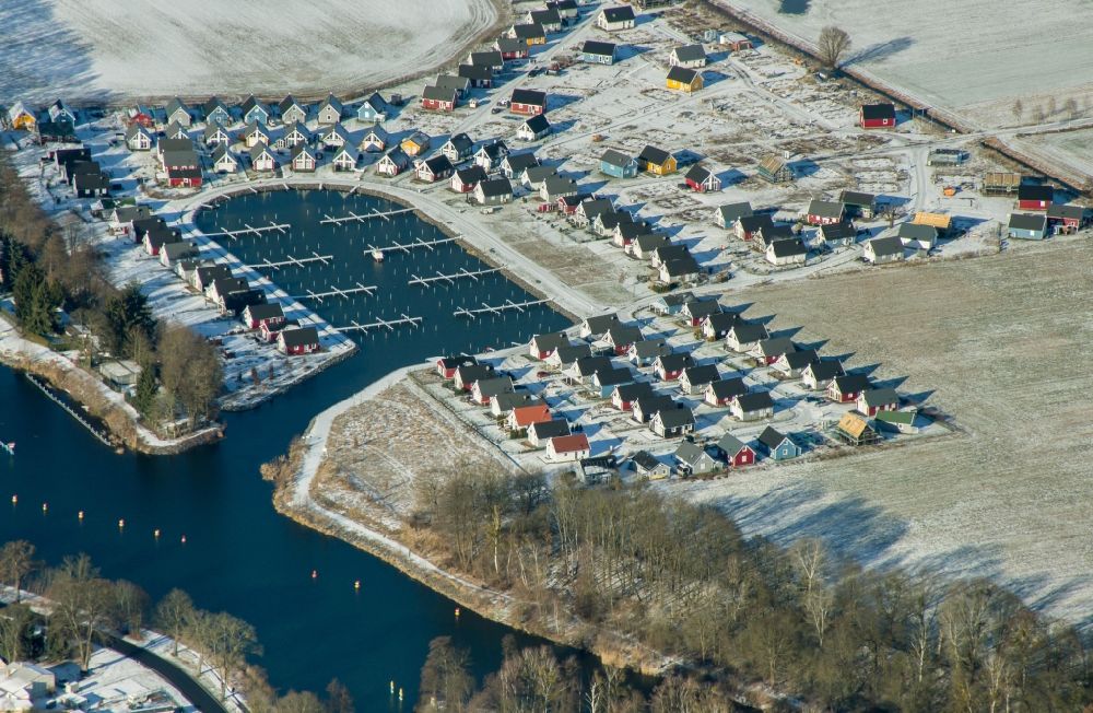Zerpenschleuse from above - Wintry snowy construction site to build new holiday apartments and to expand the holiday home complex Hafendorf Zerpenschleuse in Zerpenschleuse in the state Brandenburg, Germany
