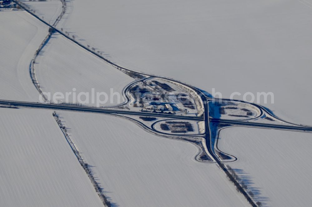 Sülzetal from above - Wintry snowy routing and traffic lanes during the exit federal highway B81 - Lindenstrasse in Suelzetal in the state Saxony-Anhalt, Germany
