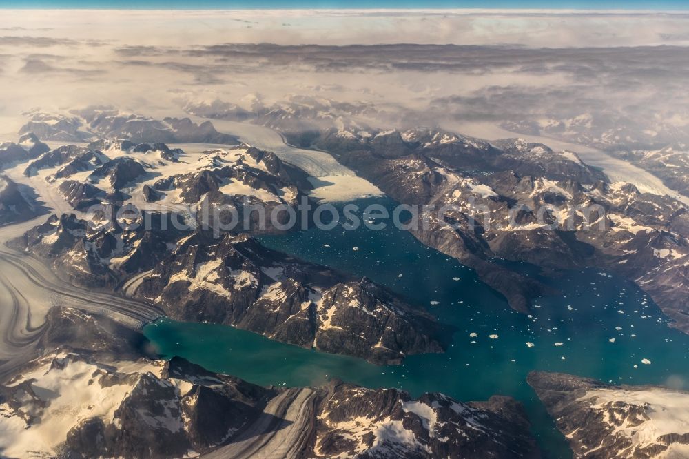 Tingmiarmit from above - Wintry snowy fjords with lake and valley glaciers in the rock and mountain landscape in Tingmiarmit in Kommuneqarfik Sermersooq, Greenland