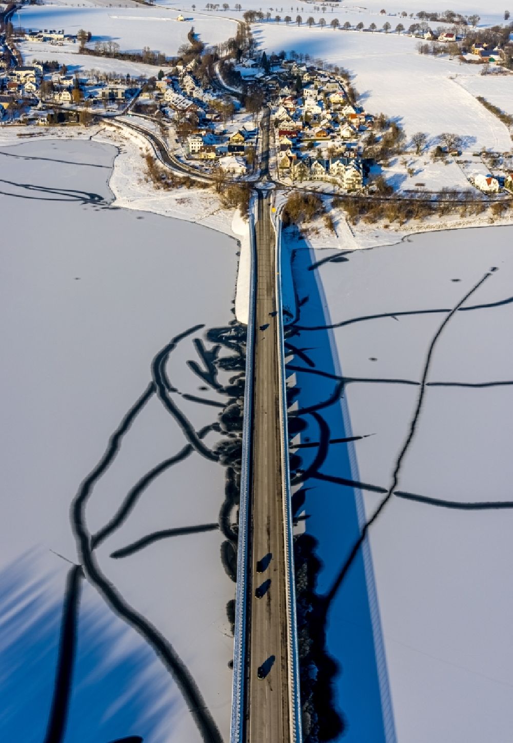 Möhnesee from above - Wintry snowy river - bridge construction der Delecker Bruecke along the Arnsberger Strasse in Moehnesee in the state North Rhine-Westphalia, Germany