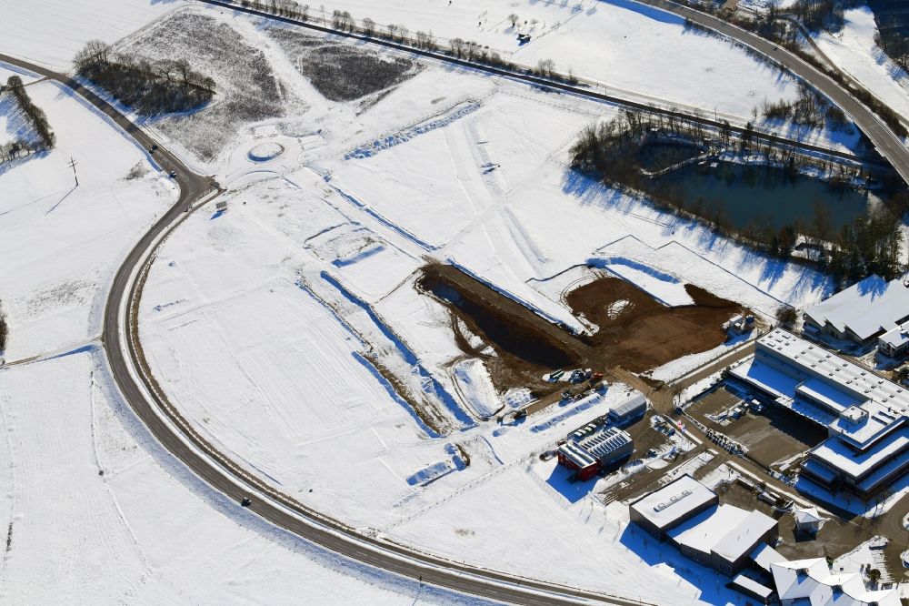 Lörrach from the bird's eye view: Wintry snowy open landscape and construction works of the new hospital of the administrative district Loerrach in the district Hauingen in Loerrach in the state Baden-Wurttemberg, Germany