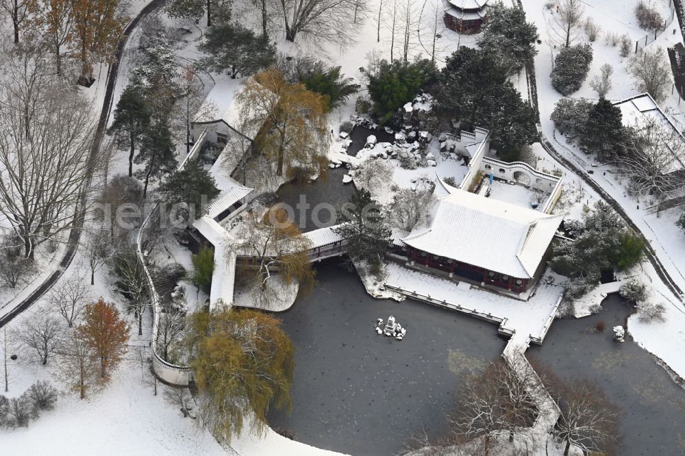 Berlin from the bird's eye view: Winter snow-covered open-air restaurant Chinese Teahouse in the Gardens of the World on Blumberger Damm Street in the Marzahn district in Berlin, Germany