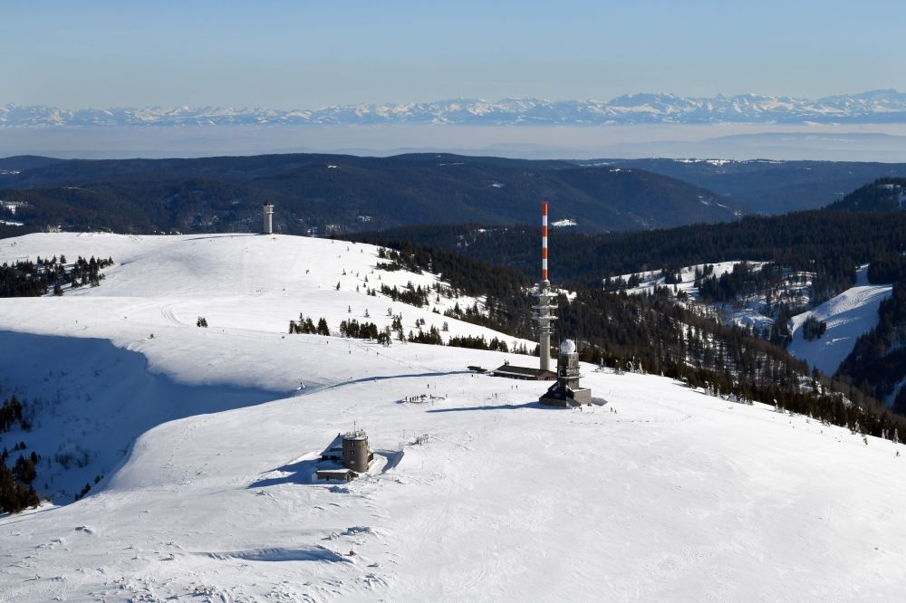 Feldberg (Schwarzwald) from above - Wintry snowy landscape at the radio tower and transmitters on the crest of the mountain Feldberg (Schwarzwald) in the Black Forest in the state Baden-Wurttemberg. Clear view to the Swiss Alps