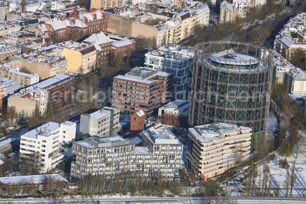 Aerial photograph Berlin - Wintry snowy gasometer high storage tank during conversion and renovation in the district Schoeneberg in Berlin, Germany