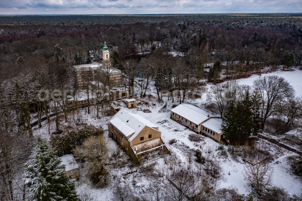 Schönwalde from above - Wintry snowy building ruins of the vacant farm building for the former supply of the Dammsmuehle Castle on Schlossstrasse in Schoenwalde in the state Brandenburg, Germany