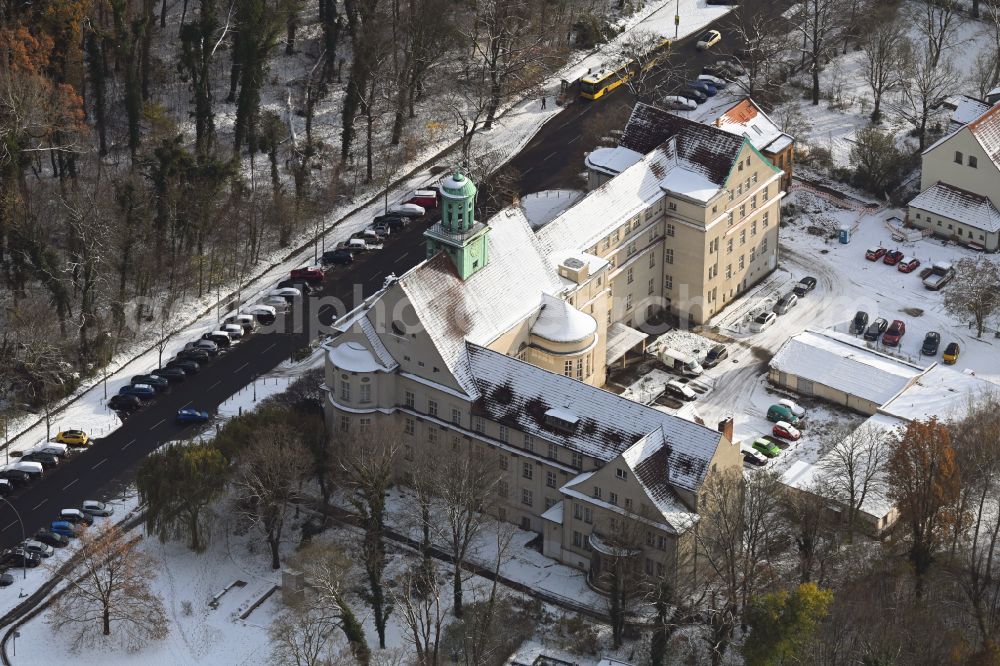 Berlin from the bird's eye view: Wintry snowy town Hall building of the city administration Treptow on street Neue Krugallee in the district Plaenterwald in Berlin, Germany