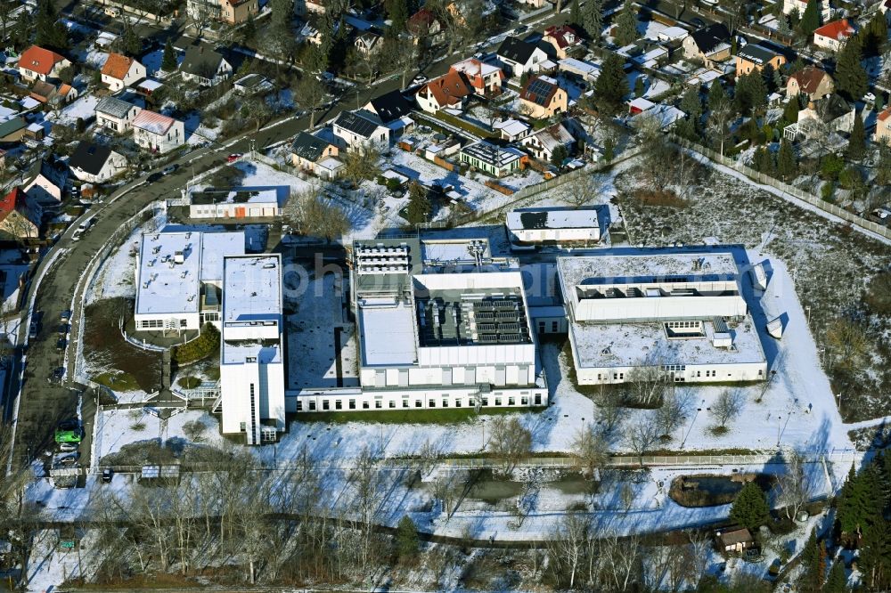 Aerial photograph Berlin - Wintry snowy building complex and grounds of the logistics center - data center of DB Systel GmbH on Florastrasse in the district Mahlsdorf in Berlin, Germany