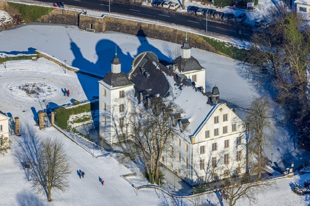 Essen from the bird's eye view: Wintry snowy building complex in the park of the castle Borbeck in Essen in the state North Rhine-Westphalia, Germany