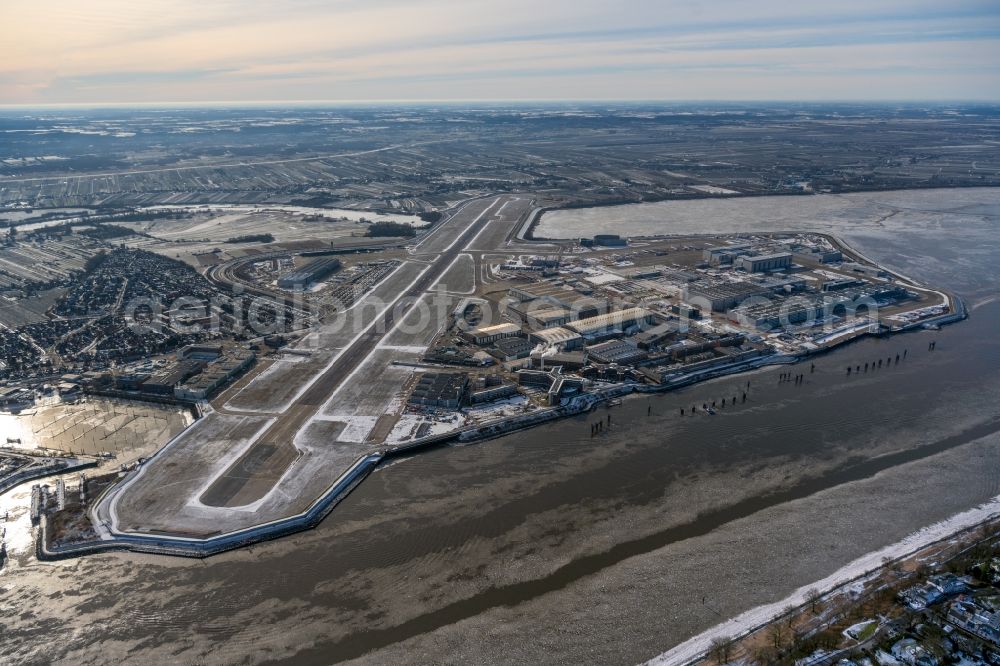 Aerial image Hamburg - Wintry snowy runway with hangar taxiways and terminals on the grounds of the airport of Airbus SE in the district Finkenwerder in Hamburg, Germany