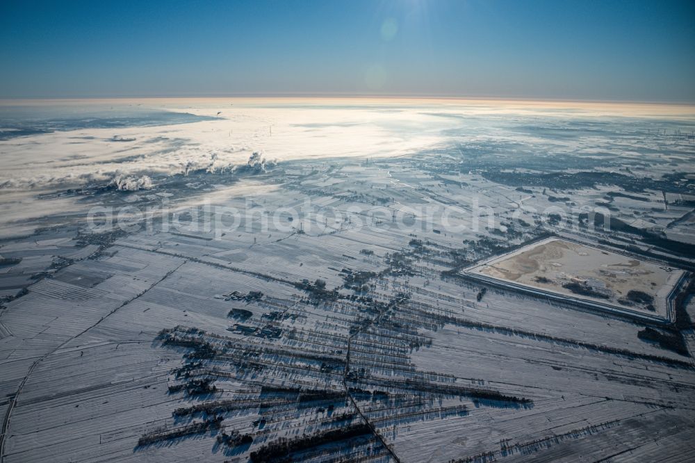 Hammah from the bird's eye view: Wintry snowy site of the red mud disposal site in Hammah in the state Lower Saxony, Germany. The red mud is a waste product resulting from the extraction of alumina