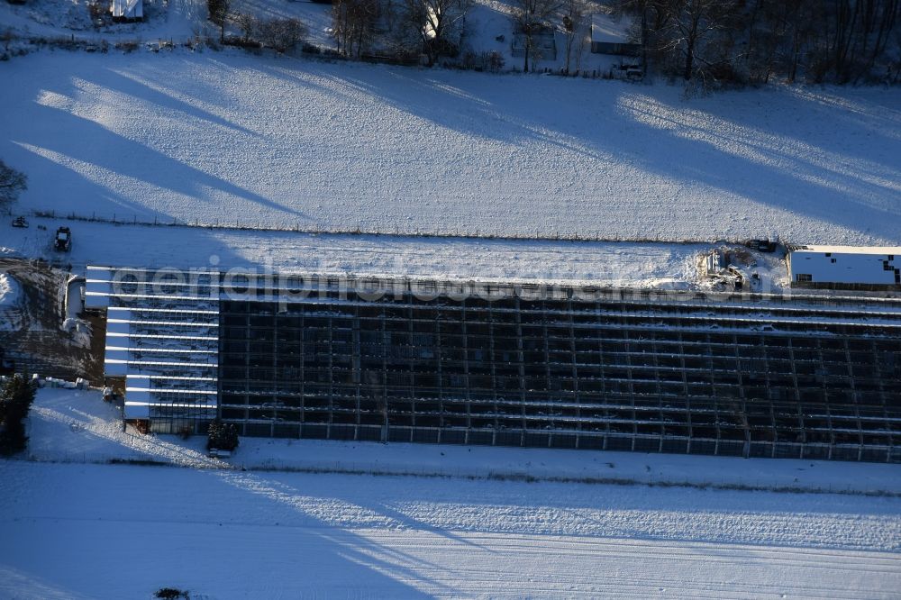 Aerial photograph Altlandsberg - Wintry snowy glass roof surfaces in the greenhouse for vegetable growing ranks in Altlandsberg in the state Brandenburg