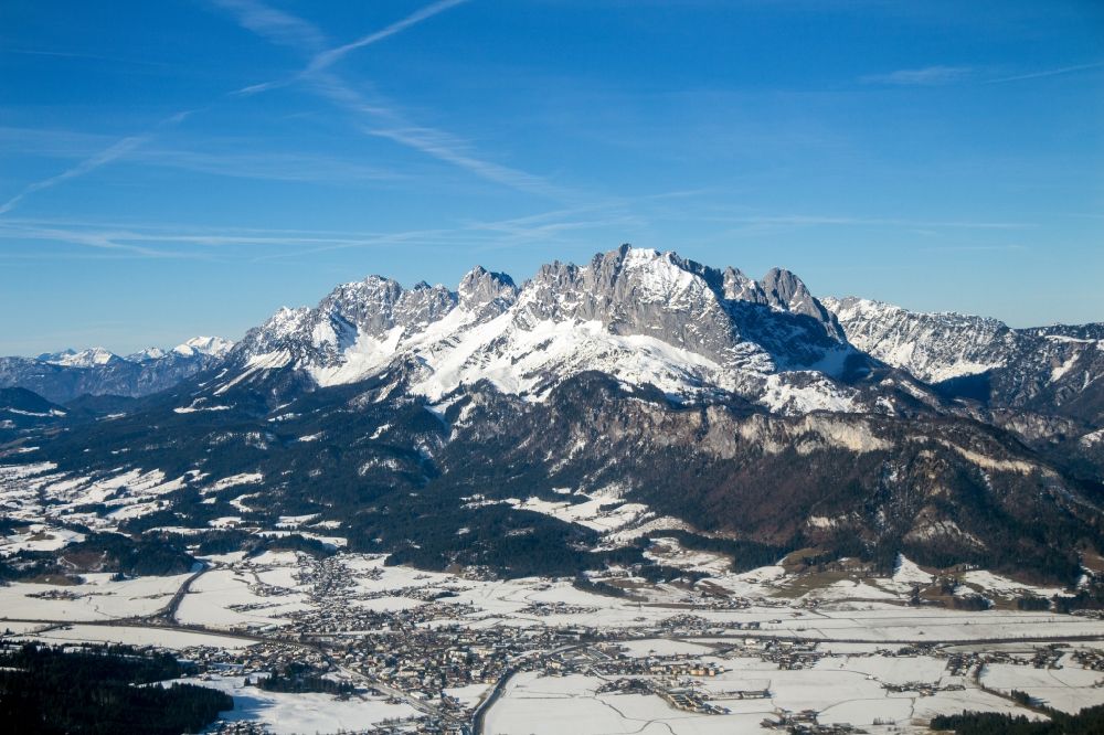 Sankt Johann from the bird's eye view: Wintry snowy rocky and mountainous landscape of Kaisergebirges in Sankt Johann in Tirol, Austria