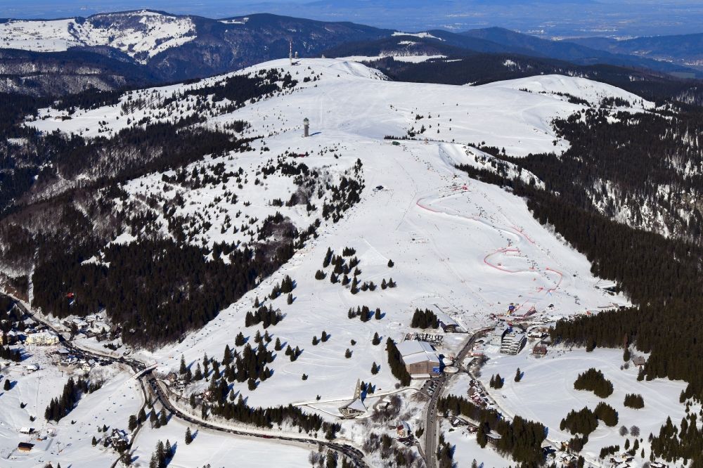 Feldberg (Schwarzwald) from above - Wintry snowy mountainous landscape of the summit of Feldberg mountain with the ski sports area and parcour at the World Cup of Ski Cross in Feldberg (Schwarzwald) in the state Baden-Wurttemberg, Germany