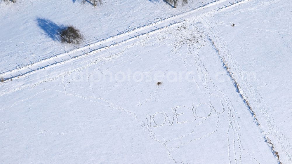 Aerial photograph Thomasberg - Wintry snowy structures of a field landscape with Schriftzug a??I love youa?? in Thomasberg in the state North Rhine-Westphalia, Germany