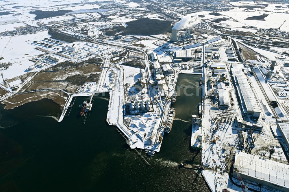 Rostock from the bird's eye view: Wintry snowy port facilities on the shores of the harbor of of Seehafen of ROSTOCK PORT GmbH in the district Peez in Rostock at the baltic sea coast in the state Mecklenburg - Western Pomerania, Germany