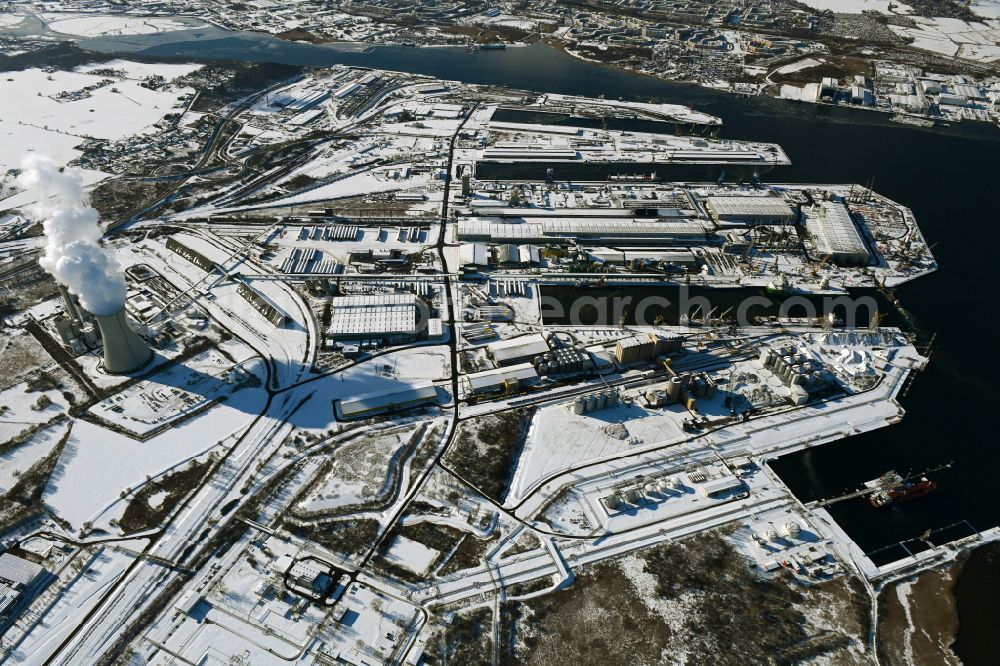 Rostock from the bird's eye view: Wintry snowy port facilities on the shores of the harbor of of Seehafen of ROSTOCK PORT GmbH in the district Peez in Rostock at the baltic sea coast in the state Mecklenburg - Western Pomerania, Germany