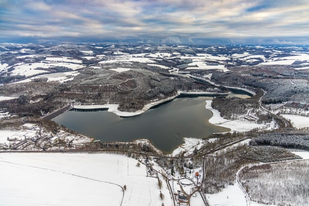 Meschede from above - Wintry snowy reservoir of the Hennesee in Meschede in the state North Rhine-Westphalia, Germany