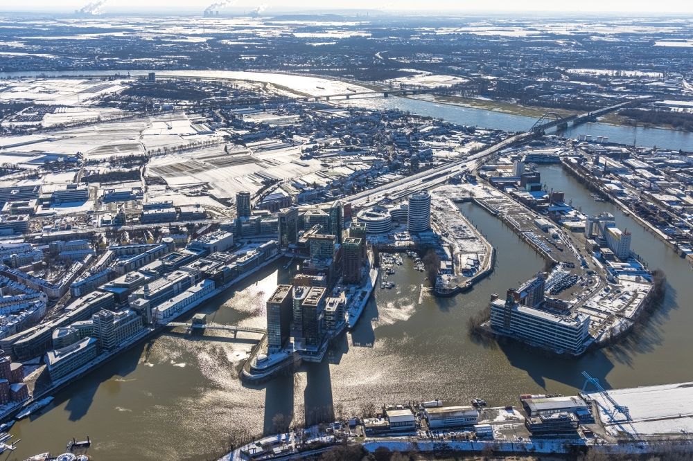 Düsseldorf from the bird's eye view: Wintry snowy high-rise building complex Duesseldorfer Heimathafen of the project WIN WIN on Speditionstrasse in Duesseldorf at Ruhrgebiet in the state North Rhine-Westphalia, Germany