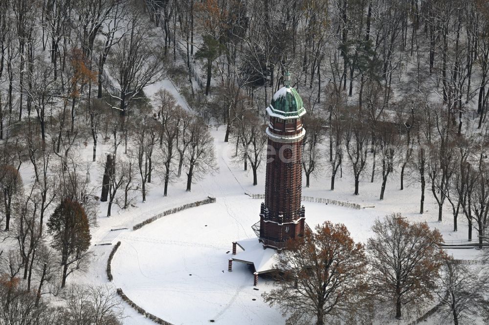 Berlin from above - Wintry snowy building of the industrial monument water tower in the summer garden Jungfernheide with the open-air restaurant summer garden Jungfernheide in Berlin, Germany
