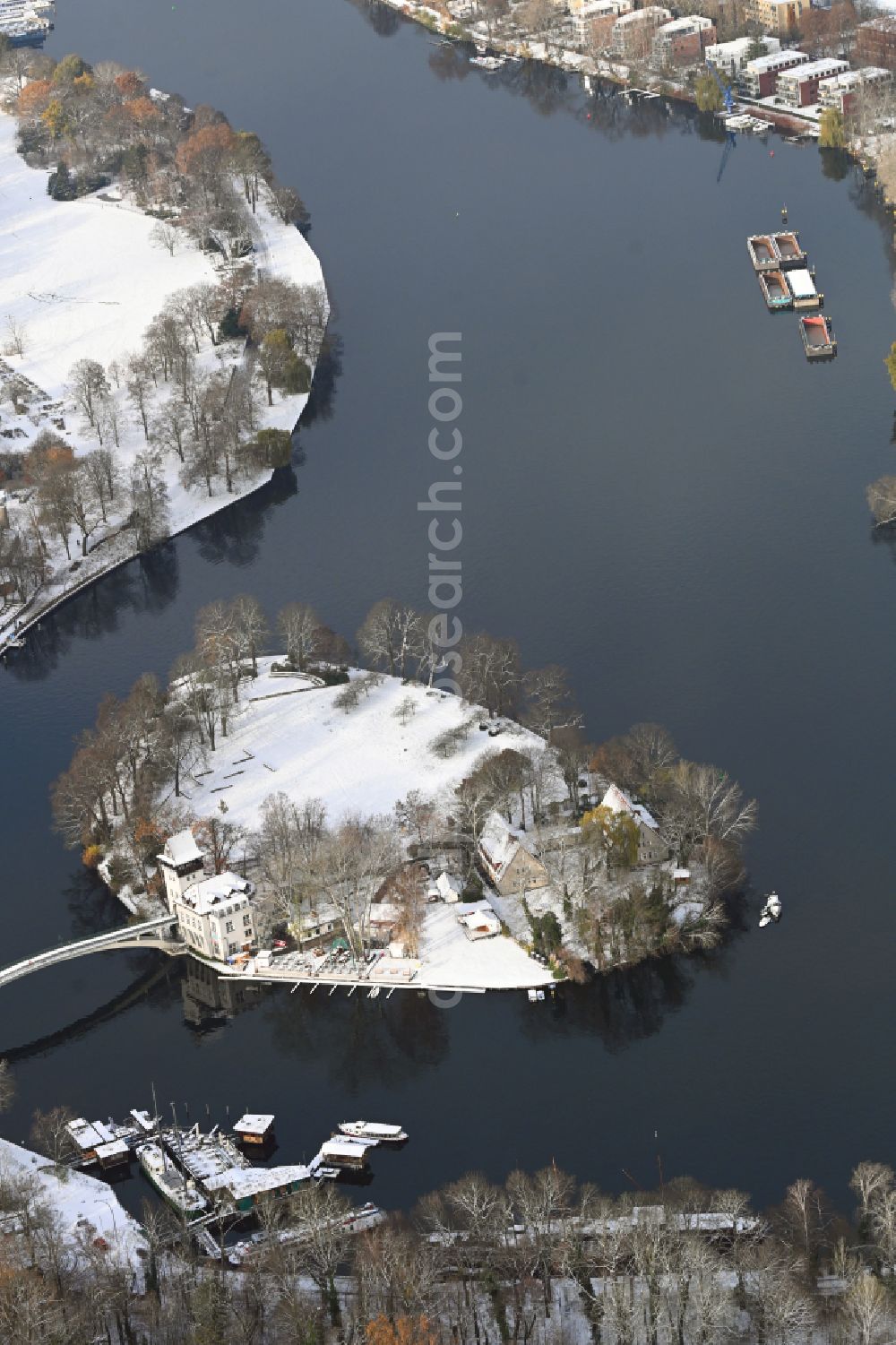 Berlin from above - Wintry snowy island on the banks of the river course of Spree River in the district Treptow in Berlin, Germany