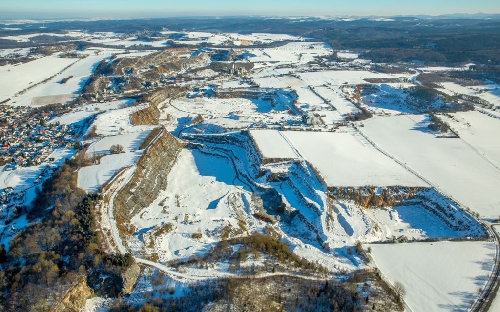 Aerial image Warstein - Wintry snowy Terrain and overburden surfaces of the chalk mine open pit of the Calcis Warstein GmbH & Co. KG in Warstein in the state North Rhine-Westphalia