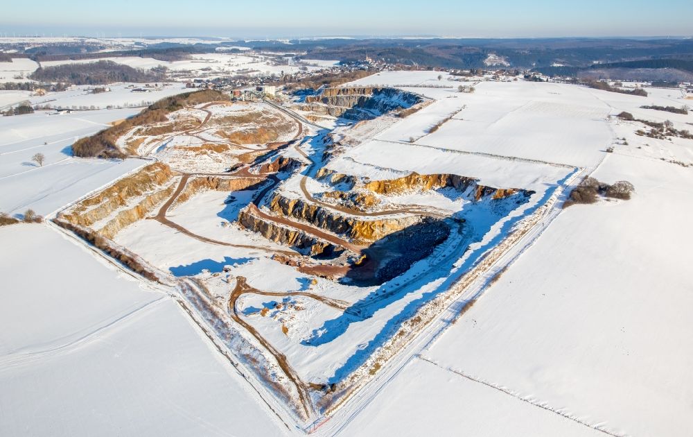 Rüthen from above - Wintry snowy Site and tailings area of the gravel mining of WESTKALK factory in the district Kallenhardt in Ruethen in the state North Rhine-Westphalia