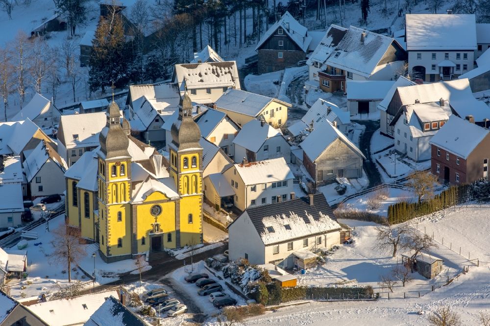 Marsberg from above - Wintry snowy church building of the cathedral of Dom Maria-Magdalena in the district Padberg in Marsberg in the state North Rhine-Westphalia
