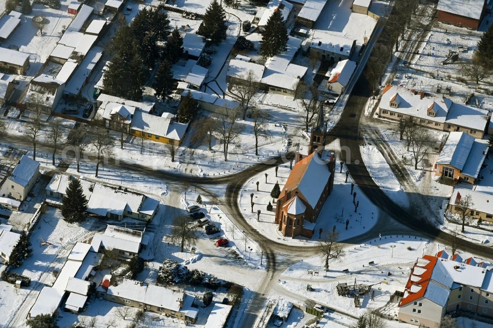 Marienwerder from the bird's eye view: Wintry snowy church building in the village of in Marienwerder in the state Brandenburg, Germany