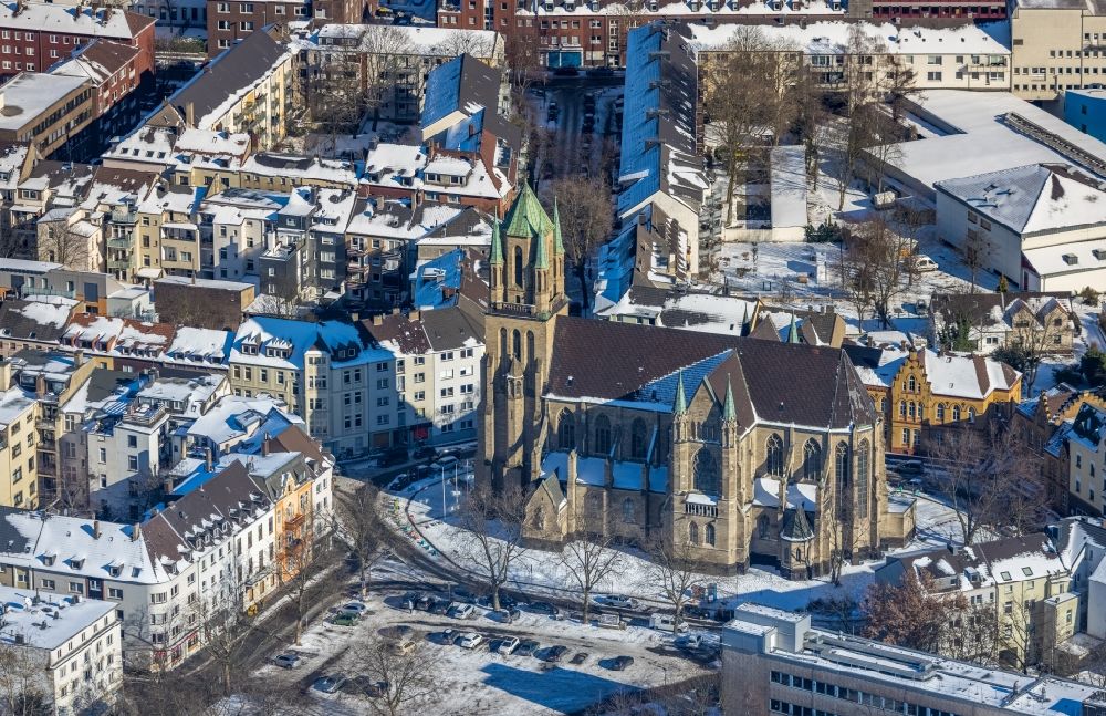 Duisburg from above - Wintry snowy church building of Kath. Gemeinde St. Ludger on Ludgeriplatz in the district Neudorf-Nord in Duisburg at Ruhrgebiet in the state North Rhine-Westphalia, Germany