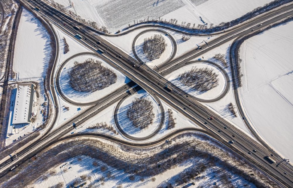 Aerial image Unna - Wintry snowy traffic flow at the intersection- motorway A4 , A1 Kreuz Dortmund/Unna in form of cloverleaf in Unna in the state North Rhine-Westphalia, Germany