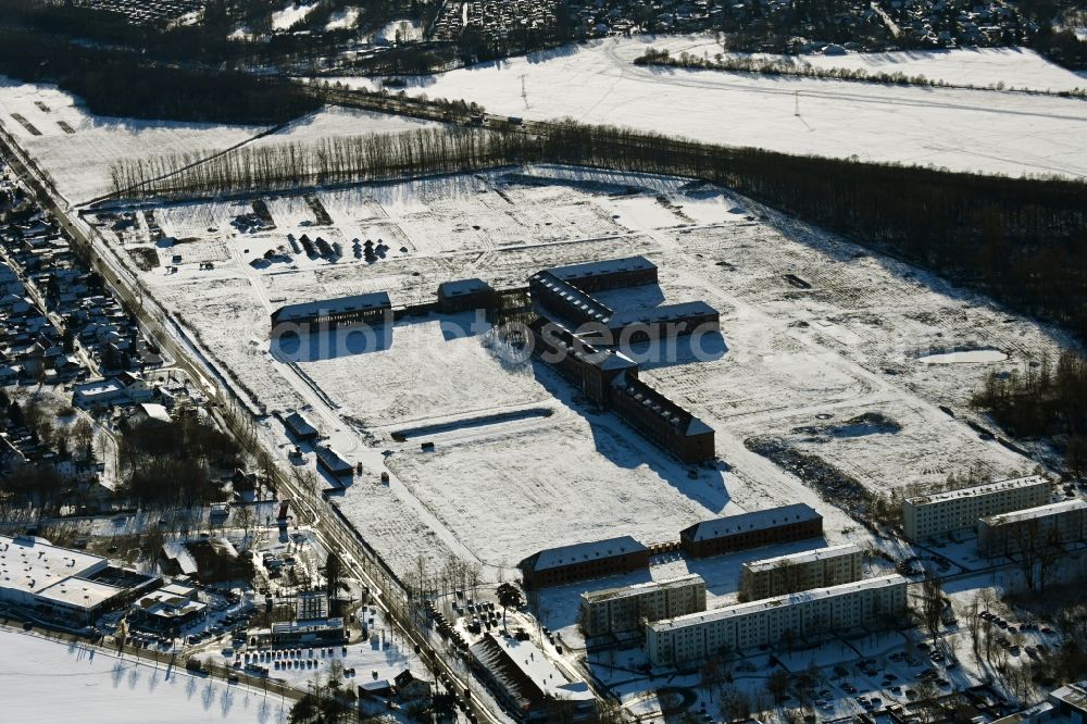 Bernau from above - Wintry snowy construction site for the renovation and reconstruction of the building complex of the former military barracks on Schwanbecker Chaussee in the district Lindow in Bernau in the state Brandenburg, Germany