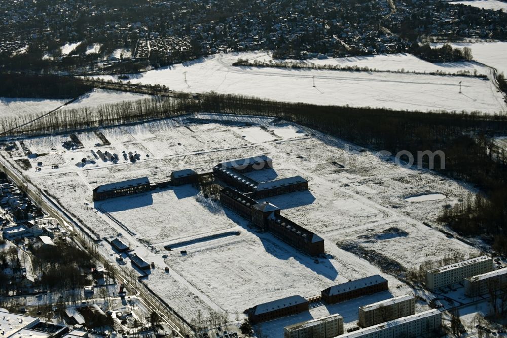 Bernau from the bird's eye view: Wintry snowy construction site for the renovation and reconstruction of the building complex of the former military barracks on Schwanbecker Chaussee in the district Lindow in Bernau in the state Brandenburg, Germany