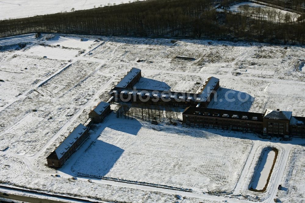 Aerial image Bernau - Wintry snowy construction site for the renovation and reconstruction of the building complex of the former military barracks on Schwanbecker Chaussee in the district Lindow in Bernau in the state Brandenburg, Germany