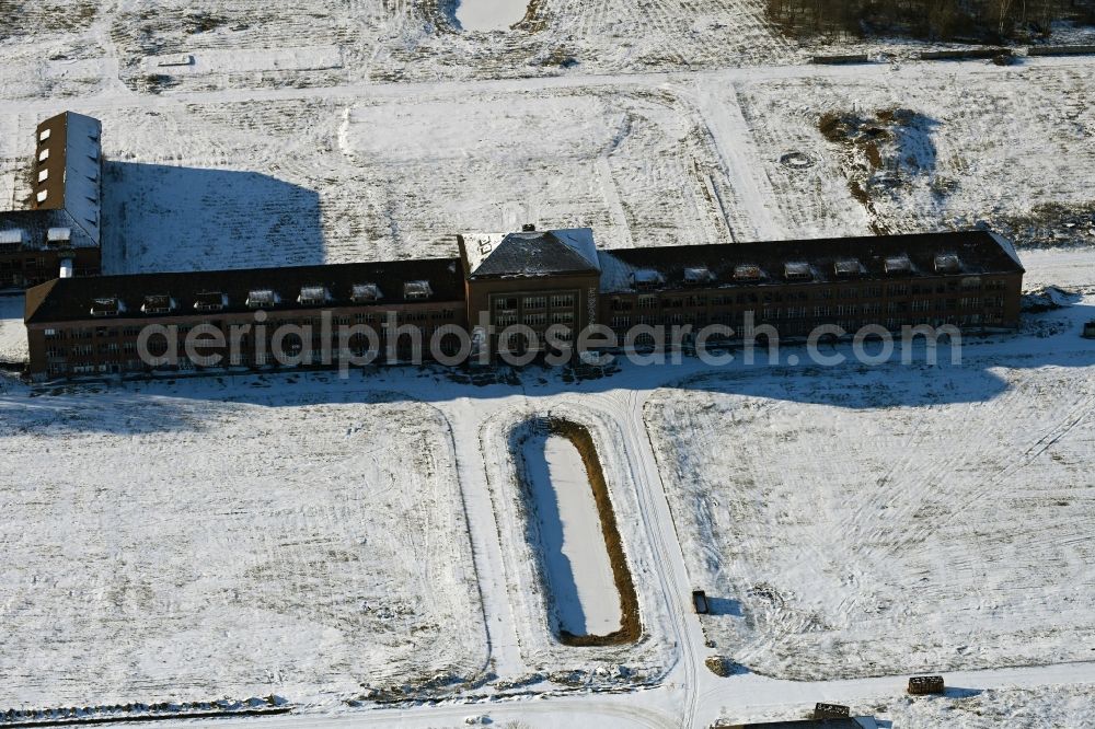 Aerial photograph Bernau - Wintry snowy construction site for the renovation and reconstruction of the building complex of the former military barracks on Schwanbecker Chaussee in the district Lindow in Bernau in the state Brandenburg, Germany