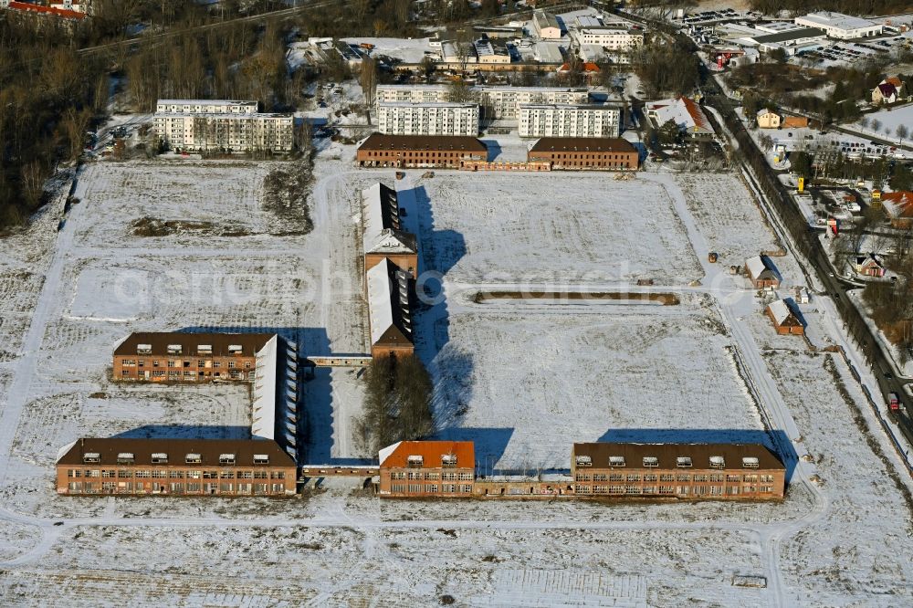 Aerial photograph Bernau - Wintry snowy construction site for the renovation and reconstruction of the building complex of the former military barracks on Schwanbecker Chaussee in the district Lindow in Bernau in the state Brandenburg, Germany